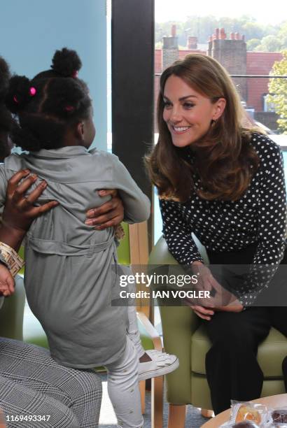 Britain's Catherine, Duchess of Cambridge gestures during her visit to the Sunshine House Children and Young People's Health and Development Centre...