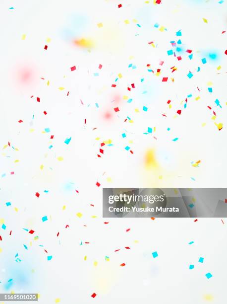 multi colored confetti against white background - fall party inside stock-fotos und bilder