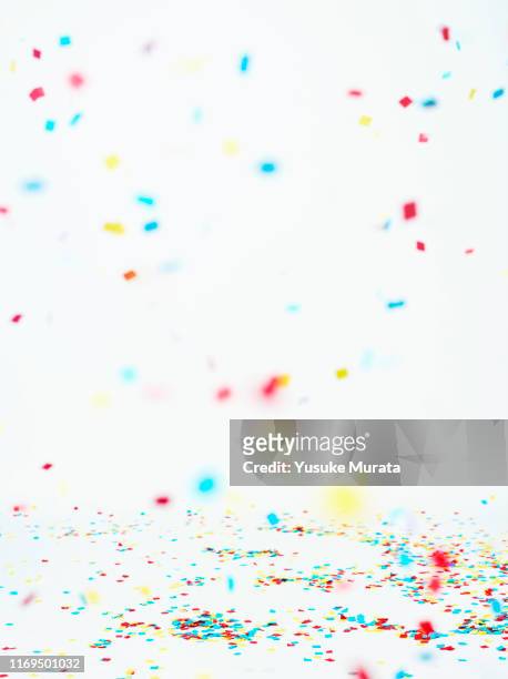multi colored confetti against white background - fall party inside stock-fotos und bilder