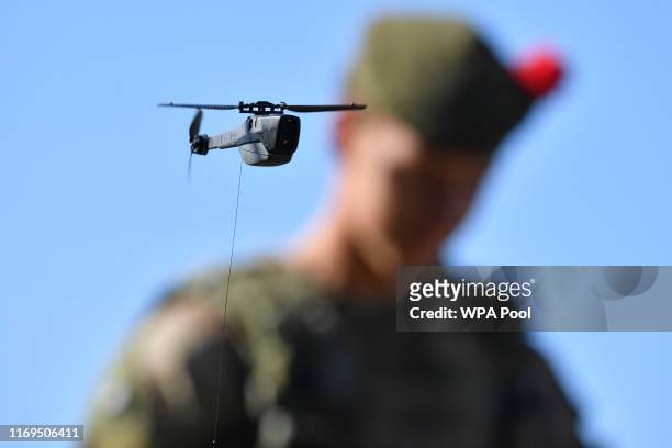 British Prime Minister Boris Johnson flies a Black Hornet nano drone during a meeting with military personnel on Salisbury plain training area on...