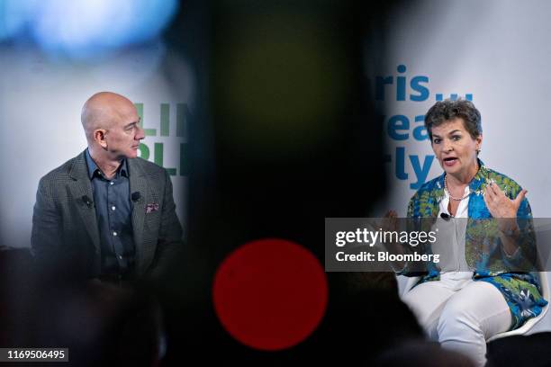 Christiana Figueres, former climate change chief at the United Nations , right, speaks as Jeff Bezos, founder and chief executive officer of...