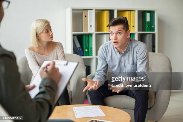 man discusses something with therapist - couple counselling stock pictures, royalty-free photos & images