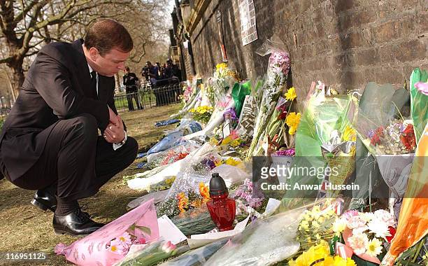 The Duke of York looks at flowers layed along The Mall in London, Wednesday April 03 in tribute to Queen Elizabeth the Queen Mother, who died last...