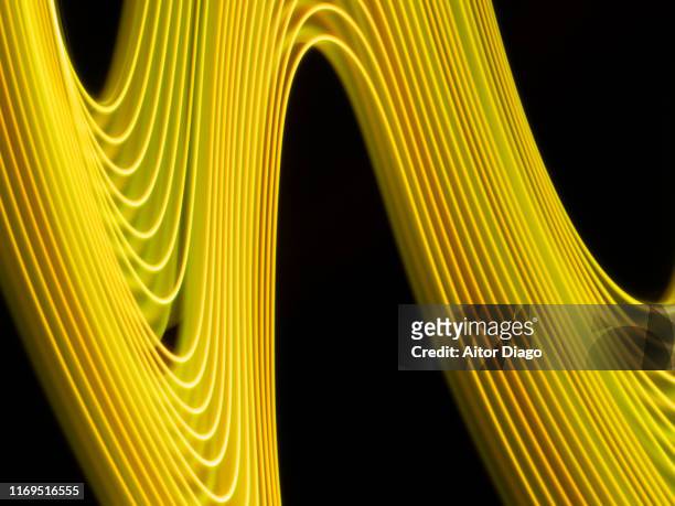 yellow curved lines with rhythm. virtual environment. 3d. - rhythm stock-fotos und bilder