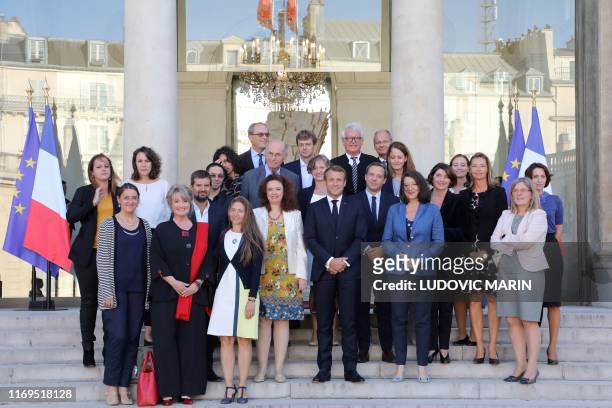 French President Emmanuel Macron and Health Minister Agnes Buzyn pose with the members of the commission entitled "the child's first 1000 days" on...