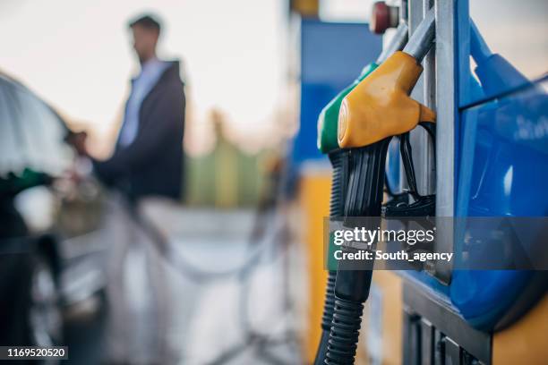 at the gas station - filling stock pictures, royalty-free photos & images