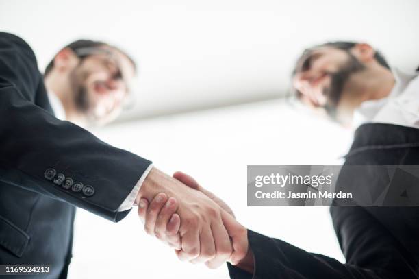 two businessmen closing successful deal - handshake abstract stock pictures, royalty-free photos & images