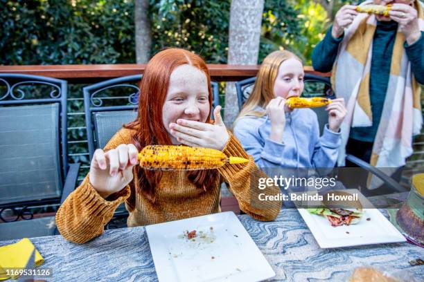 spending time with family on a cool winters afternoon. - redhead teen fotografías e imágenes de stock