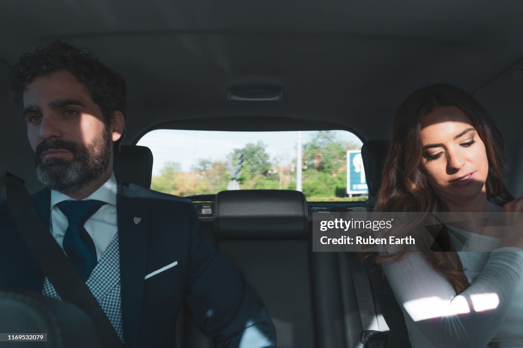 Couple on a wedding day, inside the car