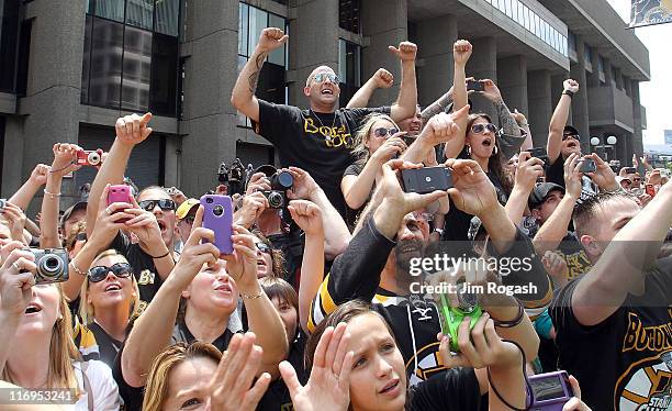 Fans of the Boston Bruins react during a Stanley Cup victory parade on June 18, 2011 in Boston, Massachusetts.