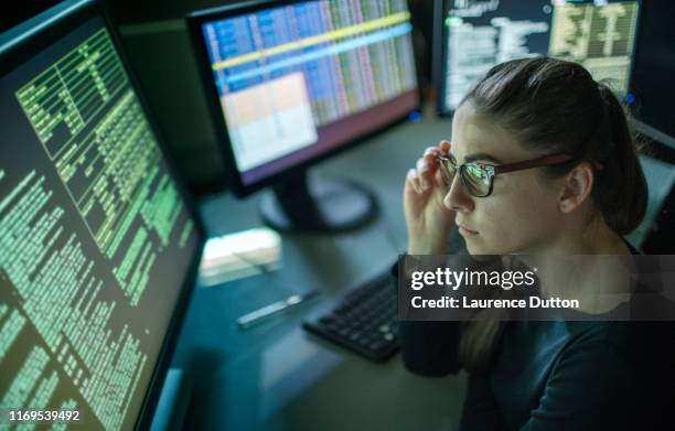 woman surrounded by monitors - mission imagens e fotografias de stock