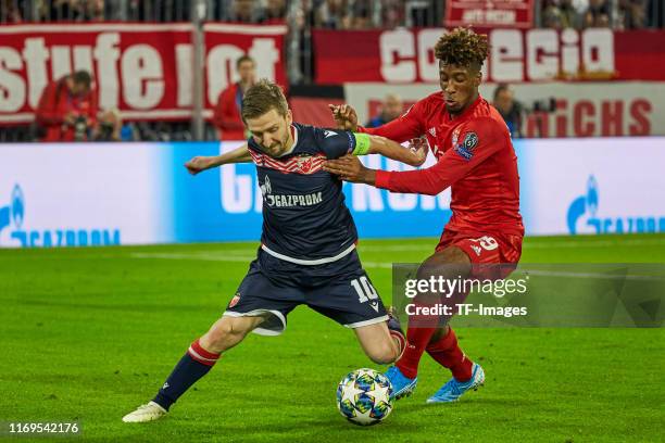 Marko Marin of Crvena Zvezda and Kingsley Coman of FC Bayern Muenchen battle for the ball during the UEFA Champions League group B match between...