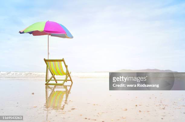 a beach chair - beach tropical deserted blue sky stock-fotos und bilder