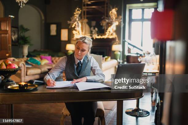 hotel receptionist working hard - hotel occupation stock pictures, royalty-free photos & images