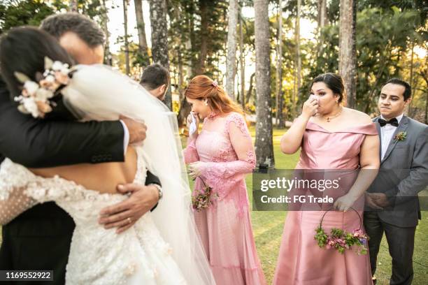 emotional bride being congratulated by her father - crying bride stock pictures, royalty-free photos & images