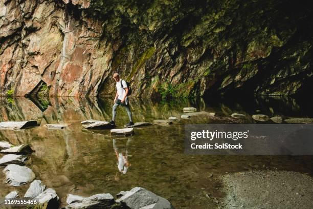 Stepping Over Rocks Stepping Stone Man Photos and Premium High Res Pictures - Getty Images