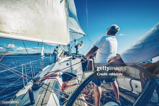 sailing crew on sailboat on regatta - regatta stock pictures, royalty-free photos & images