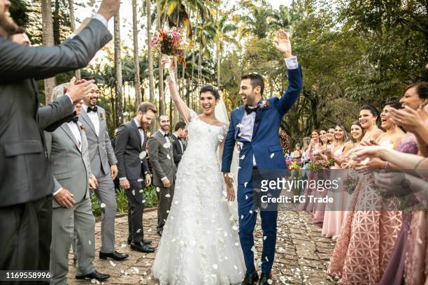 confetti throwing on happy newlywed couple - wedding ceremony stock pictures, royalty-free photos & images