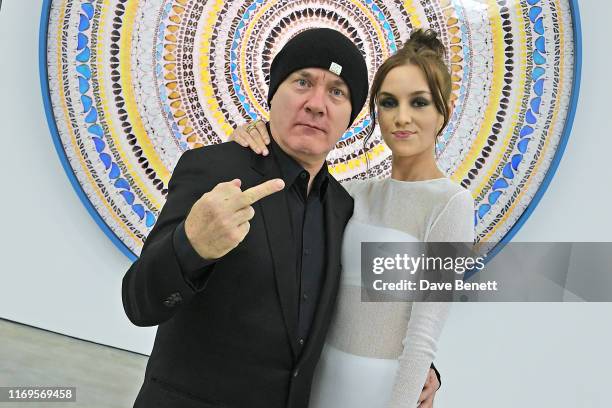 Damien Hirst and Sophie Cannell attend a private view of "Damien Hirst: Mandalas" at White Cube Gallery on September 19, 2019 in London, England.