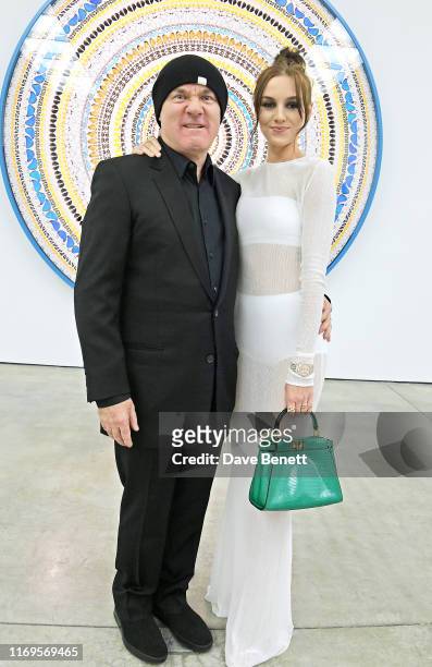 Damien Hirst and Sophie Cannell attend a private view of "Damien Hirst: Mandalas" at White Cube Gallery on September 19, 2019 in London, England.