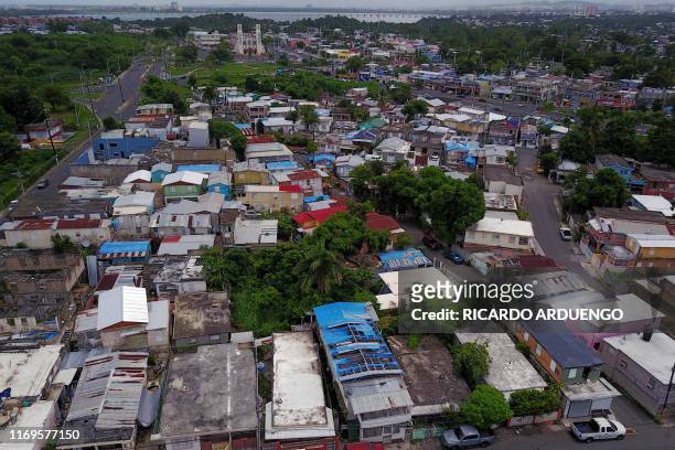 Blue tarps given out by FEMA cover several roofs two years after Hurricane Maria affected the island in San Juan, Puerto Rico, September 18, 2019. -...