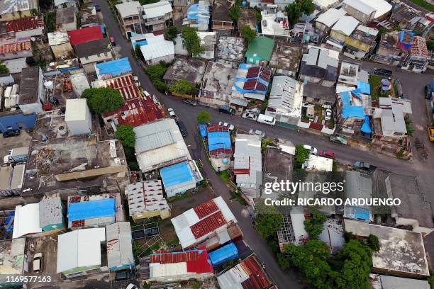 Blue tarps given out by FEMA cover several roofs two years after Hurricane Maria affected the island in San Juan, Puerto Rico, September 18, 2019. -...