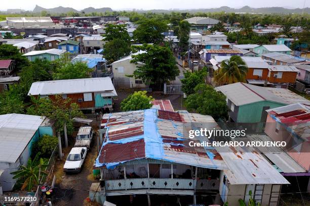 The blue tarp that was used to protect the roof damaged by Hurricane Maria two years ago is showing wear and tear in San Juan, Puerto Rico, September...