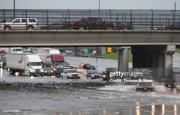 Cars pull to the side of the freeway of highway 69 North to get by the flood waters on September 19, 2019 in Houston, Texas. Gov. Greg Abbott has...