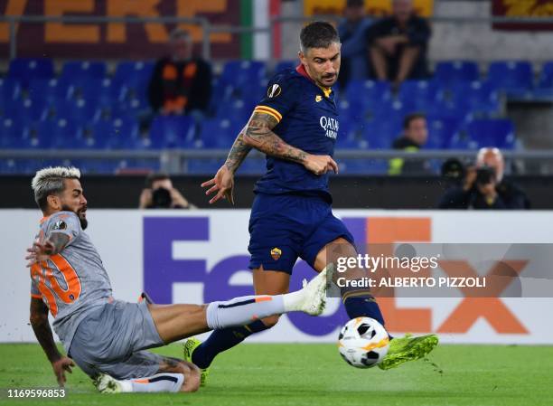 Roma's Serbian defender Aleksandar Kolarov centres the ball despite Istanbul Basaksehir FK's Brazilian defender Junior Caicara during the UEFA Europa...