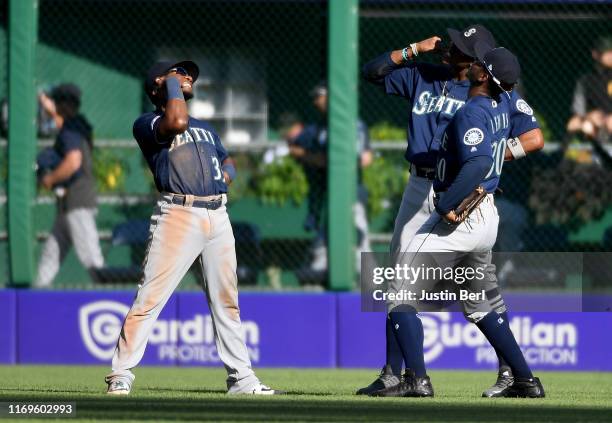Shed Long of the Seattle Mariners celebrates with Keon Broxton and Kyle Lewis after the final out in a 6-5 win over the Pittsburgh Pirates at PNC...