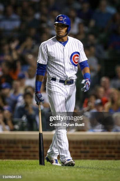 Addison Russell of the Chicago Cubs walks back to the dugout after striking out in the seventh inning against the San Francisco Giants at Wrigley...