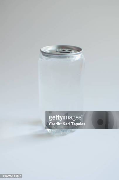 a plastic and tin soda can on a white background - cannette photos et images de collection