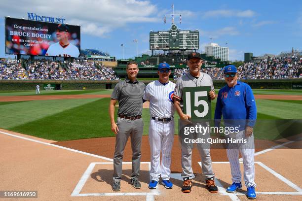 Theo Epstein, Mark Loretta, and Joe Maddon of the Chicago Cubs, pose with Bruce Bochy of the San Francisco Giants before the game to honor is...