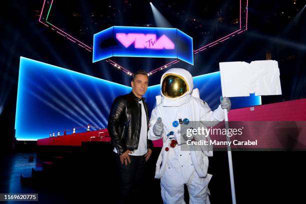 Host Sebastian Maniscalco poses with the moon man at the 2019 MTV Video Music Awards at Prudential Center on August 22, 2019 in Newark, New Jersey.