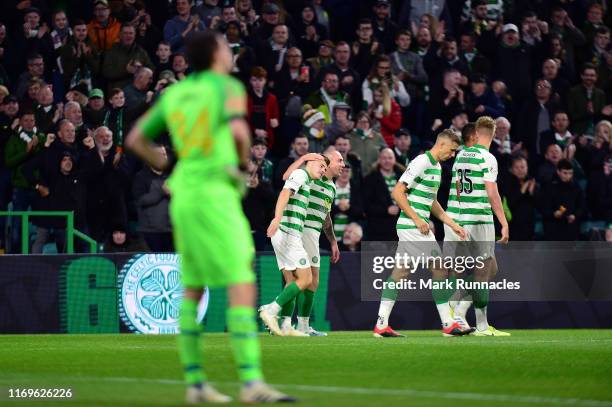 Celtic celebrate with James Forrest after he scored the opening goal during the UEFA Europa League Play Off First Leg match between Celtic and AIK at...