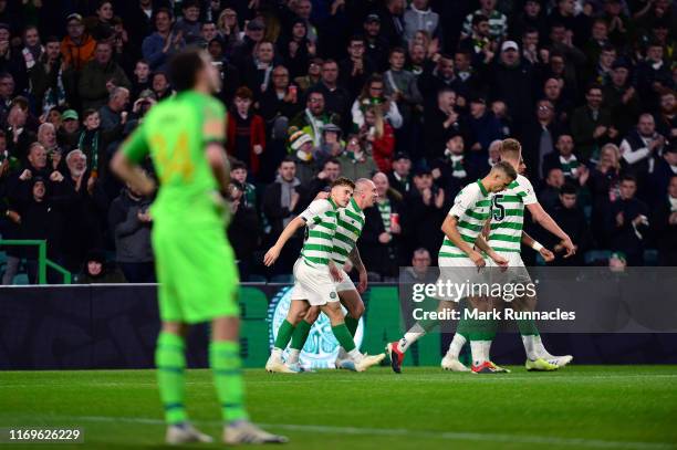 Celtic celebrate with James Forrest after he scored the opening goal during the UEFA Europa League Play Off First Leg match between Celtic and AIK at...
