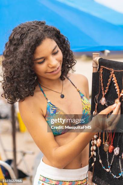 tourist buying costume jewelry at the beach - varadero beach stock pictures, royalty-free photos & images