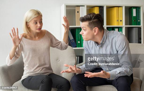 angry husband talking with wife - conspiracy stock pictures, royalty-free photos & images