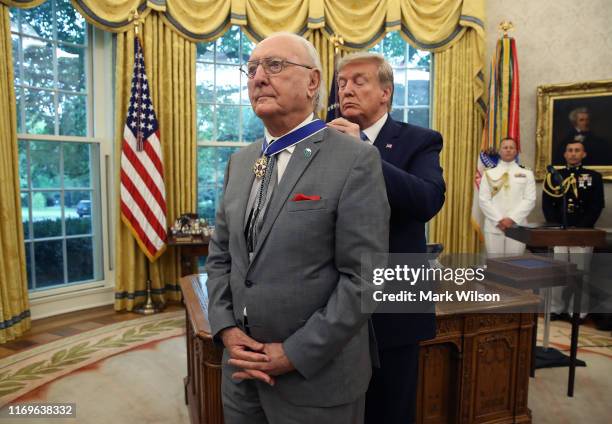 President Donald Trump presents the Medal of Freedom to retired Boston Celtic Bob Cousy in the Oval Office at the White House on August 22, 2019 in...