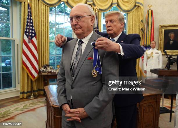 President Donald Trump presents the Medal of Freedom to retired Boston Celtic Bob Cousy in the Oval Office at the White House on August 22, 2019 in...