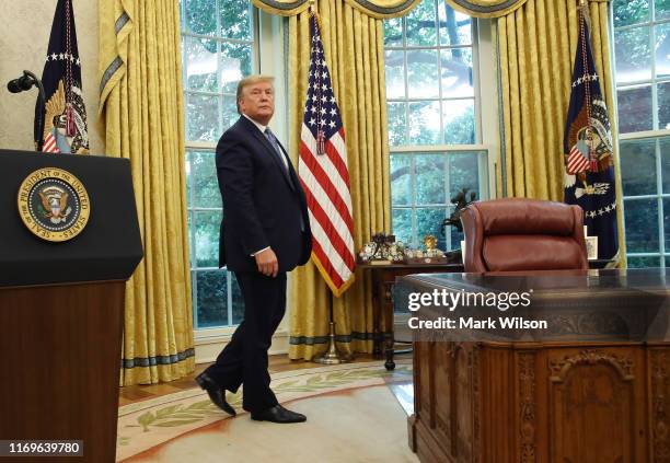 President Donald Trump walks away after presenting the Medal of Freedom to retired Boston Celtic Bob Cousy in the Oval Office at the White House on...