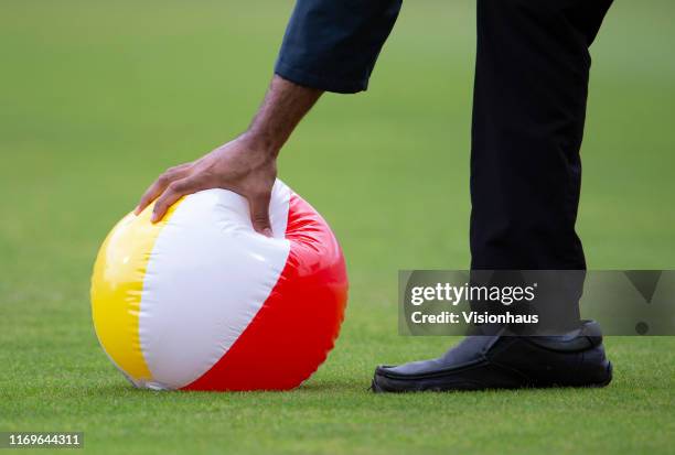 Steward grabs an inflatable beach ball during day one of the 3rd Ashes Test match between England and Australia at Headingley on August 22, 2019 in...