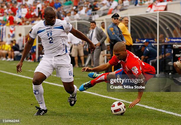 Alvaro Saborio of Costa Rica is knocked to the ground by Osman Chavez of Honduras playing the ball during the 2011 Gold Cup Quarterfinals on June 18,...