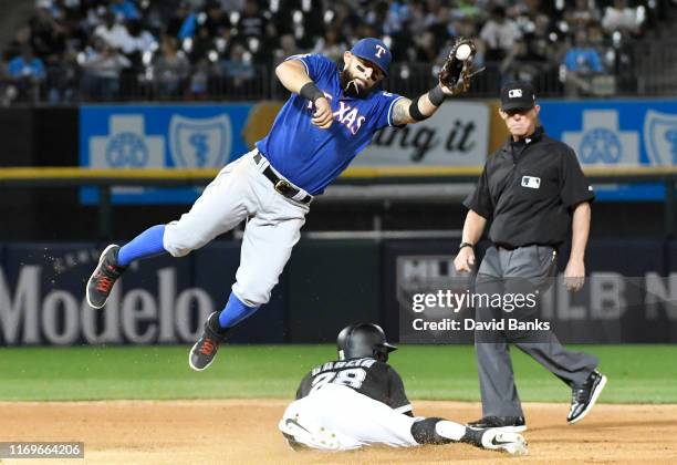 Leury Garcia of the Chicago White Sox steals second base as Rougned Odor of the Texas Rangers takes a high throw during the fourth inning at...