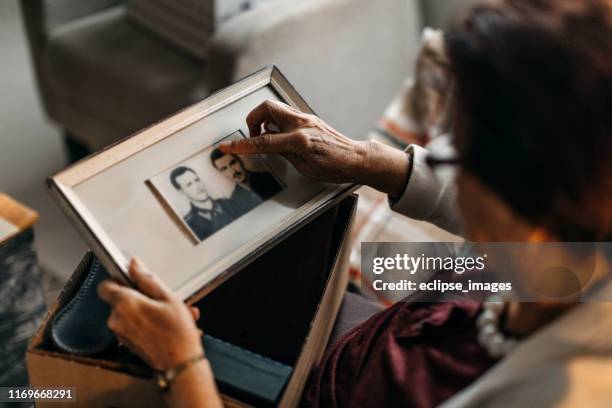 i like to remember the good old days - woman holding picture frame stock pictures, royalty-free photos & images