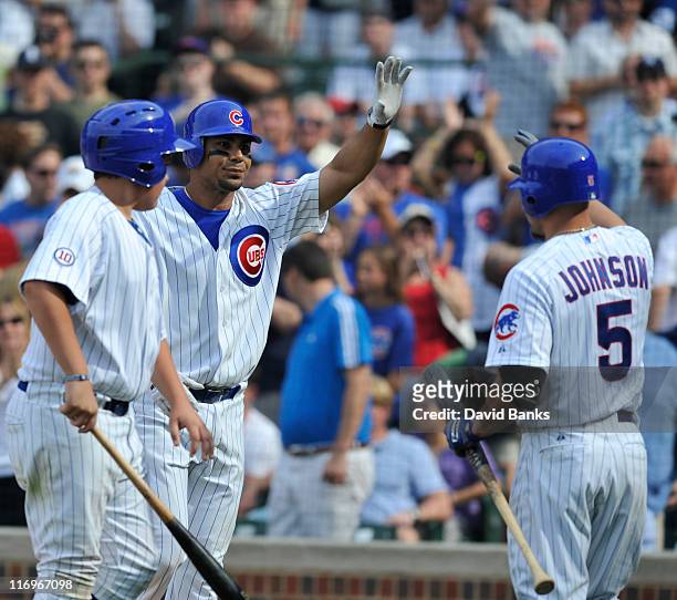 Carlos Pena of the Chicago Cubs after hitting a 2-run home run gets high fives from Reed Johnson against the New York Yankees in the fourth inning on...