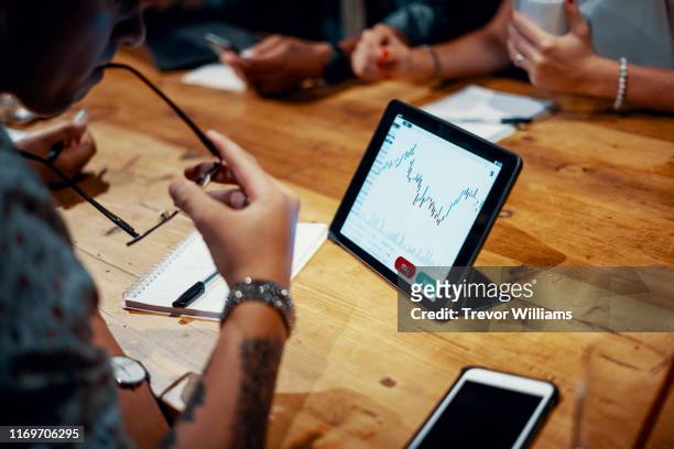 mixed group of millennial aged friends discuss investing and cryptocurrency trading - big tech foto e immagini stock