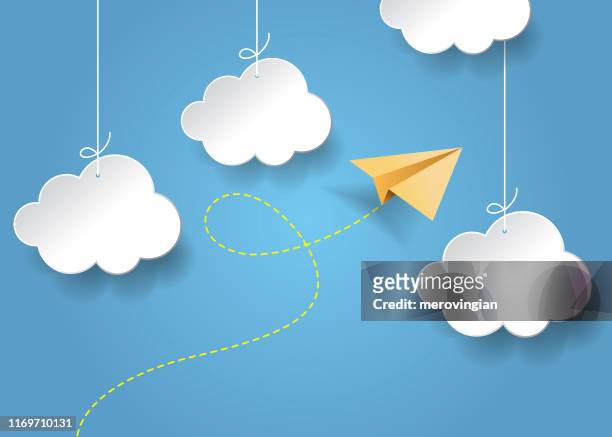 flying paper airplane. plane and clouds with shadow on blue background - paper aeroplane stock illustrations