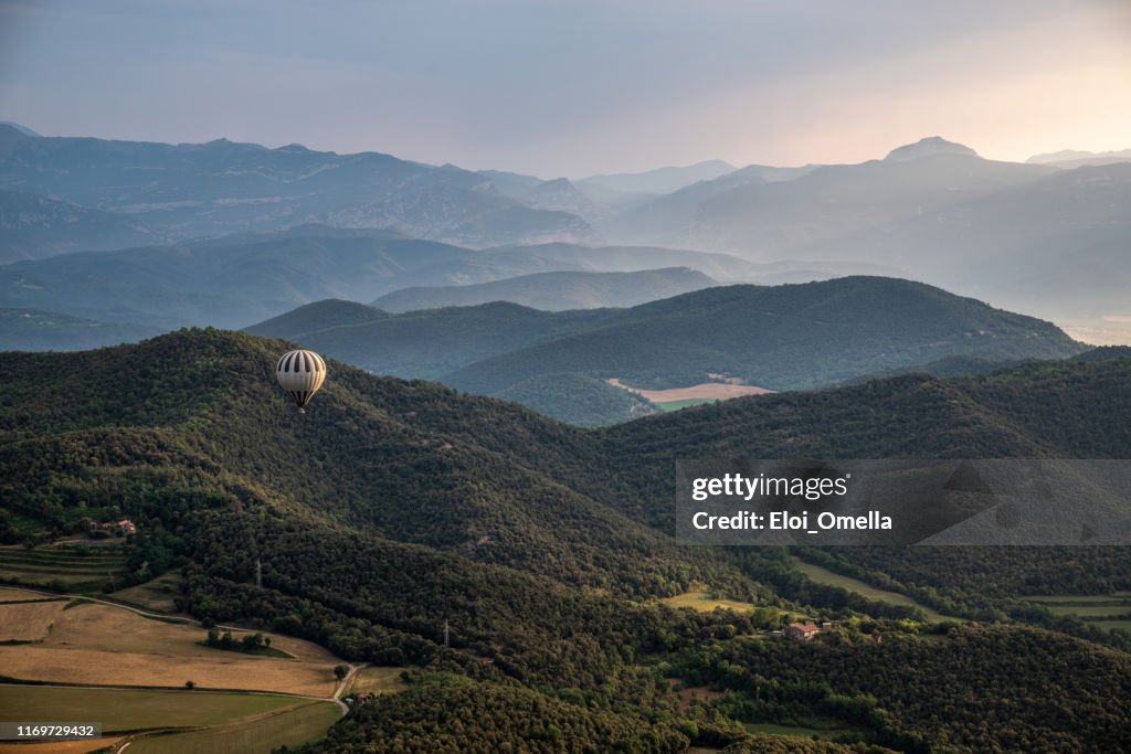 Air Balloon over misty lanscape volcanos in la Garrotxa, Gerona province, Catalonia, Spain