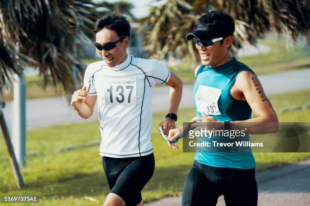 blind triathlete running and training with his guide - blind man stock pictures, royalty-free photos & images